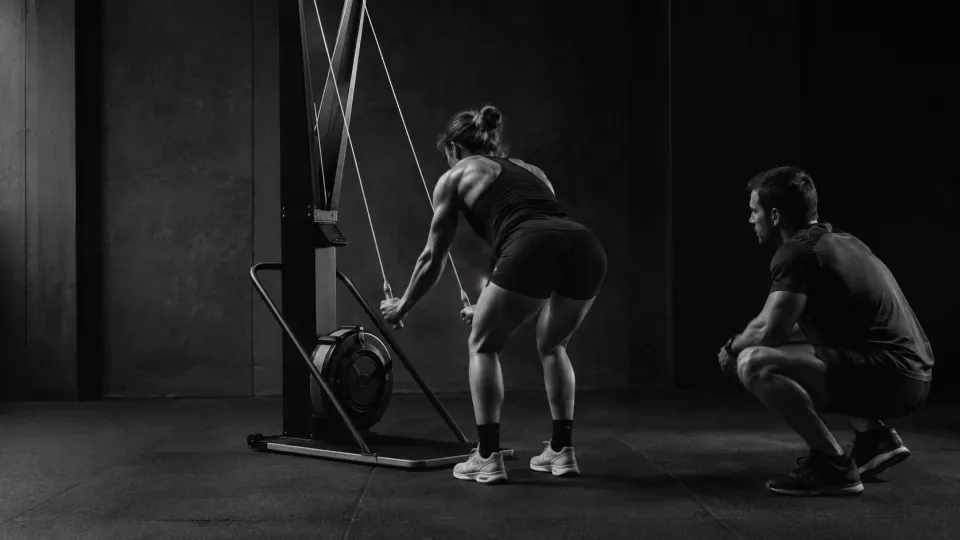 コーチとSkiErgの動きを確認する選手のAI生成イメージ